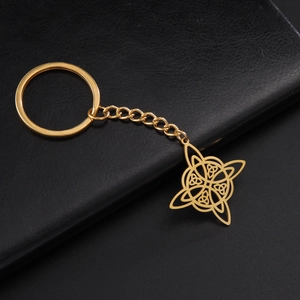 Macro shot of gold stainless steel Celtic knot pendant with chain on black leather