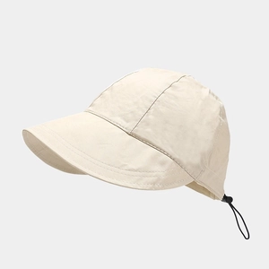 Detail of light beige sun hat showing quick-dry fabric texture and black adjustable cord