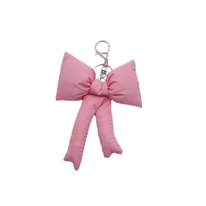 Pink fabric bow keychain accessory with silver metal clasp and lobster hook for bags