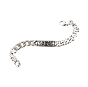 Detail of silver Cuban chain bracelet featuring an engraved square star plate and lobster clasp