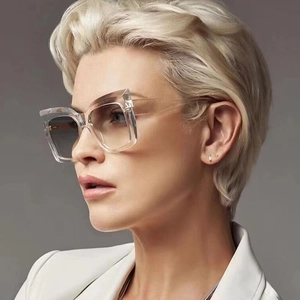 Transparent oversized cat-eye sunglasses with grey gradient lenses worn on model