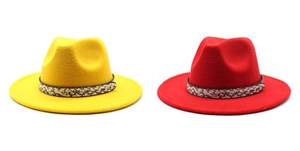 Detail of red and yellow wool fedora hats with ethnic patterned woven hatbands