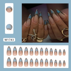 24pcs long stiletto press-on nails with nude base, blue French tips, and gold lining accents