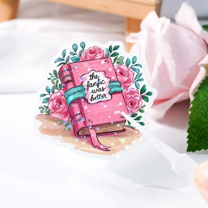 Close-up of holographic laser sticker with rose book design and star glitter finish