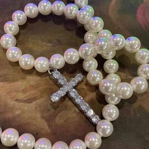 Men's retro pearl necklace featuring a sparkling rhinestone cross pendant on dark background