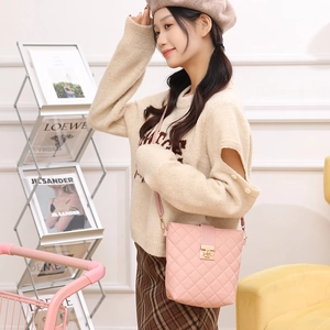 Chic pink quilted crossbody bag with gold twist lock and diamond stitch pattern