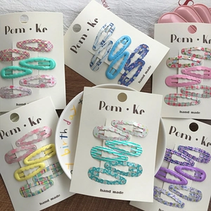 Cute wavy BB hair clip set with floral and plaid patterns on white display cards
