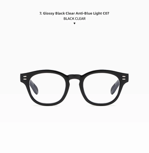 Close-up of shiny black oval frame sunglasses with silver stud detail and clear lenses