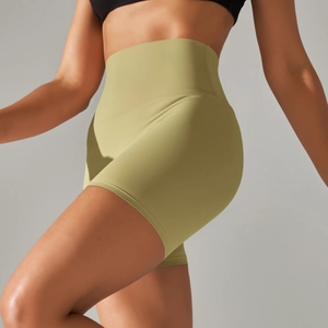 Detail of high-waisted olive green yoga shorts with seamless contouring and matte texture