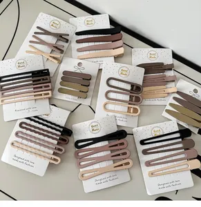 Flat lay of matte resin hair clips in earth tones on a minimalist display card