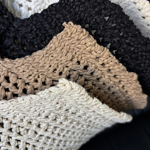 Foldable knit bucket hat in white, black, and khaki with intricate hand-crocheted textures