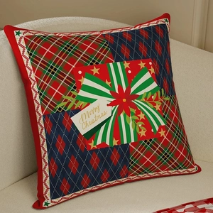 Christmas pillow cover with red green plaid patchwork and gift box design on sofa