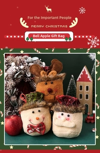 Detailed view of plush drawstring Christmas gift bags with reindeer and Santa designs