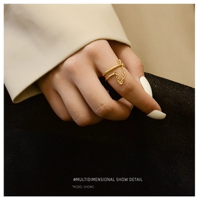 Detail view of 18K gold-plated double-layer ring featuring a minimalist link chain design
