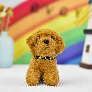 Close-up of a cute brown plush teddy dog keychain featuring a gold star collar decoration