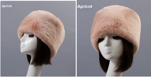 Detailed view of plush apricot faux fur winter hat texture and cossack round top design
