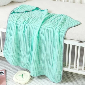 Detail of mint green 6-layer cotton gauze baby blanket with soft breathable texture