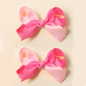 Detail of pink and magenta gradient ribbon hair bows for babies in a high-quality macro view