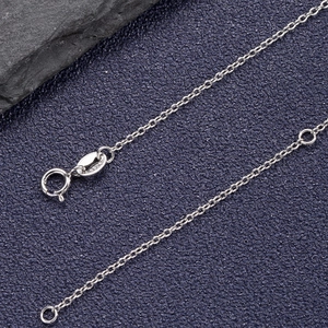 Close-up of S925 sterling silver lobster clasp and fine chain on a dark textured background