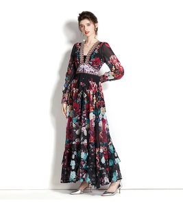 Macro detail of the deep V-neckline and vibrant floral pattern on chiffon fabric