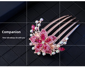 Detailed macro view of the five-tooth rose gold floral hair comb with pink rhinestones