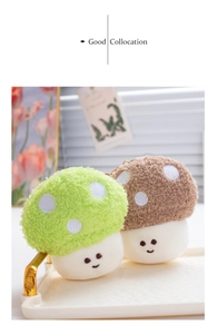 Detail of plush mushroom charms in green and brown with cute embroidered faces