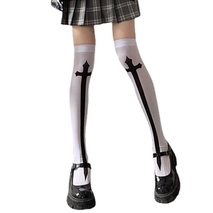 White over knee socks featuring black cross print paired with dark plaid skirt