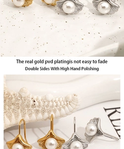 Detailed macro view of PVD gold plated ginkgo leaf earrings with polished pearls
