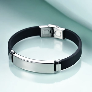 Close-up of a 12mm black silicone and silver stainless steel men's ID bracelet with mirror finish