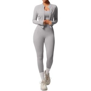 Three-piece light grey yoga set including zip jacket, sports bra, and high-waist leggings
