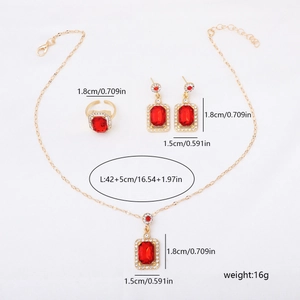 Macro shot of gold jewelry set with rectangle red gemstones and white diamond accents