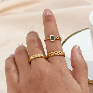 Detailed view of three 18K gold plated rings with black stone and star zircon accents