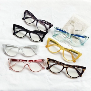 Cat eye glasses frames in black and diverse colors on textured fabric background