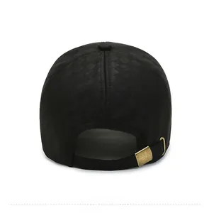 Detail view of the checkered pattern and adjustable bronze buckle on the black baseball cap