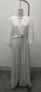 Detail of silk-like V-neck shirt and silver sequin wide-leg trousers with thin belt