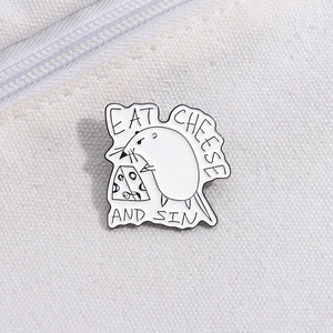 Close-up of a mouse eating cheese enamel pin with Eat Cheese and Sin text on canvas