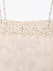 Close-up of lace-trimmed neck and woven strap details on linen camisole set