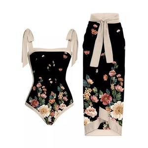 Detail of floral two-piece swimsuit with ribbon straps and a matching beach sarong wrap