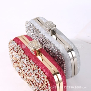 Close-up of rose red and silver glitter evening bags with intricate floral rhinestone patterns