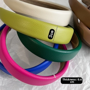 Detail of 3cm wide leather headband showing various colors and lychee texture