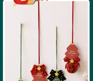 Detail of Christmas tree pendants with ribbons and metallic star patterned bells