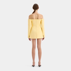 Detail of yellow off-shoulder mini dress featuring golden buttons on long sleeves back view