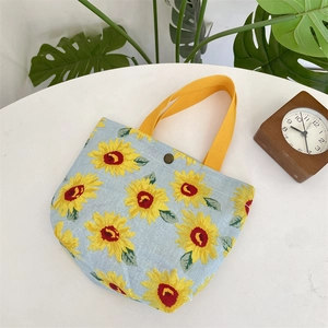 Detailed view of sunflower canvas tote with yellow handle and metal snap button