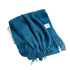 Classic navy blue knitted scarf with fringes and handmade label on a white tray