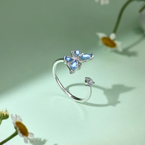 Detail of S925 silver ring featuring a blue marquise zircon butterfly and open band