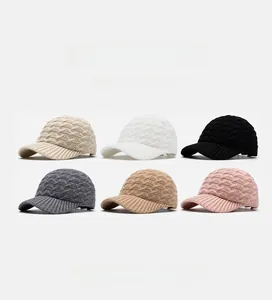 Detail view of winter knitted baseball caps in six colors with classic cable knit texture