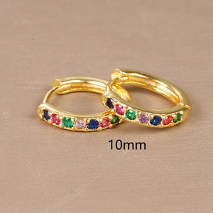 Detail of 10mm gold huggie hoop earrings with multi-color cubic zirconia inlay