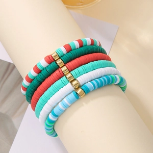 Detail of bohemian colorful heishi clay bead bracelets with gold metal spacer accents