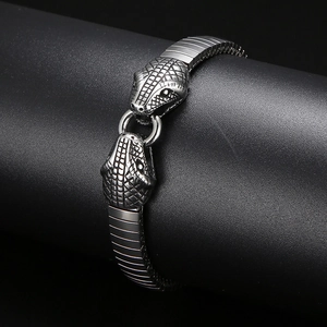 Detailed macro view of punk style double snake head clasps on a steel men's bracelet
