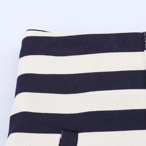 Macro shot of blue and white striped twill cotton fabric with detailed stitching